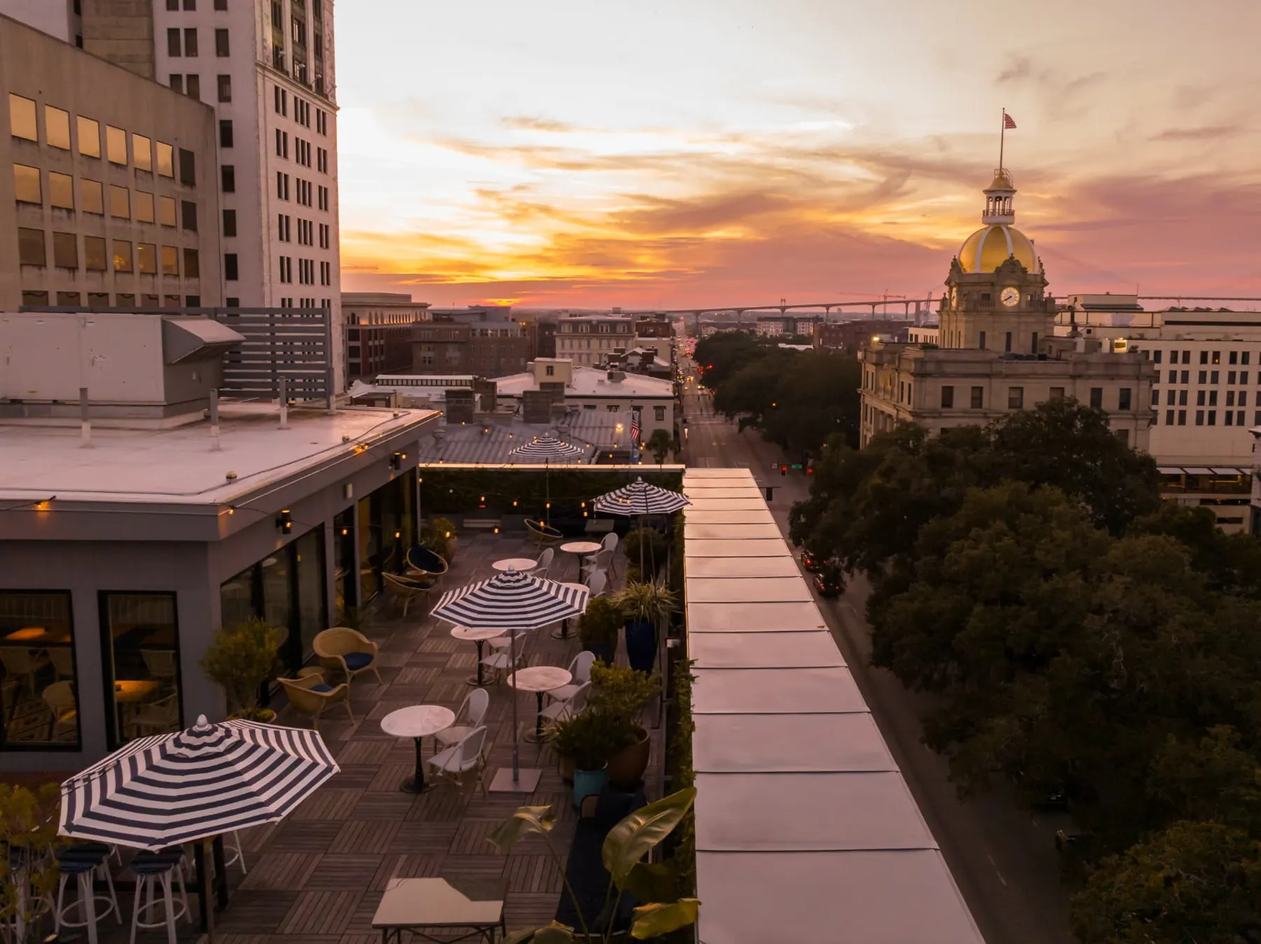 Pendant rooftop terrace overlooking Savannah City Hall's gold dome at sunset